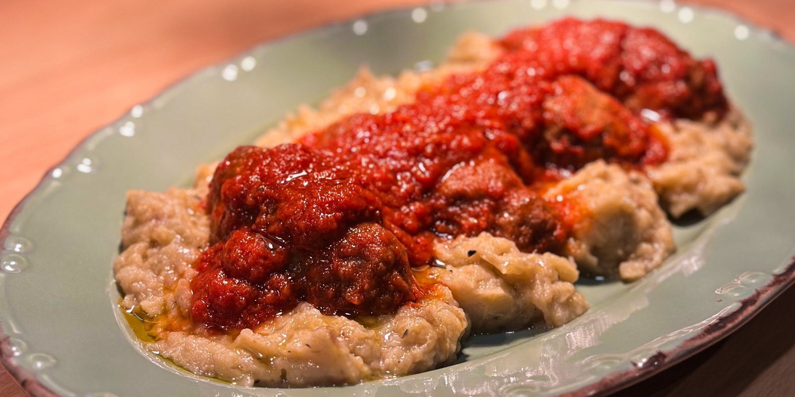 Soutzoukakia in tomato sauce over smoked eggplant puree