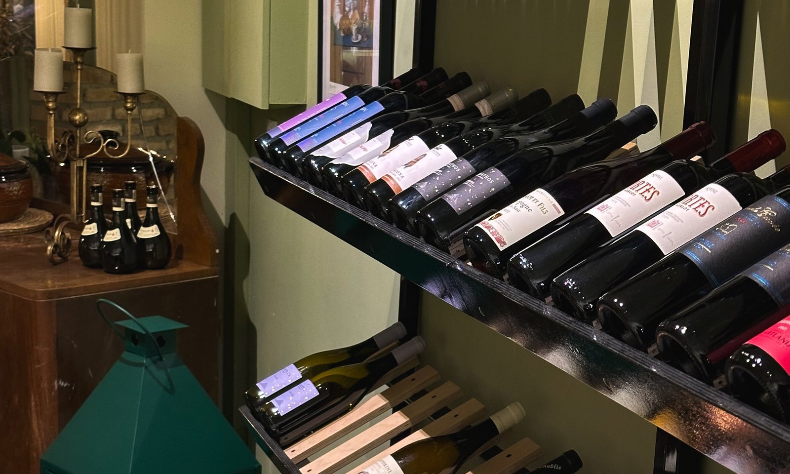 Bottles of red, white and rose lying on the wine rack in the dining room