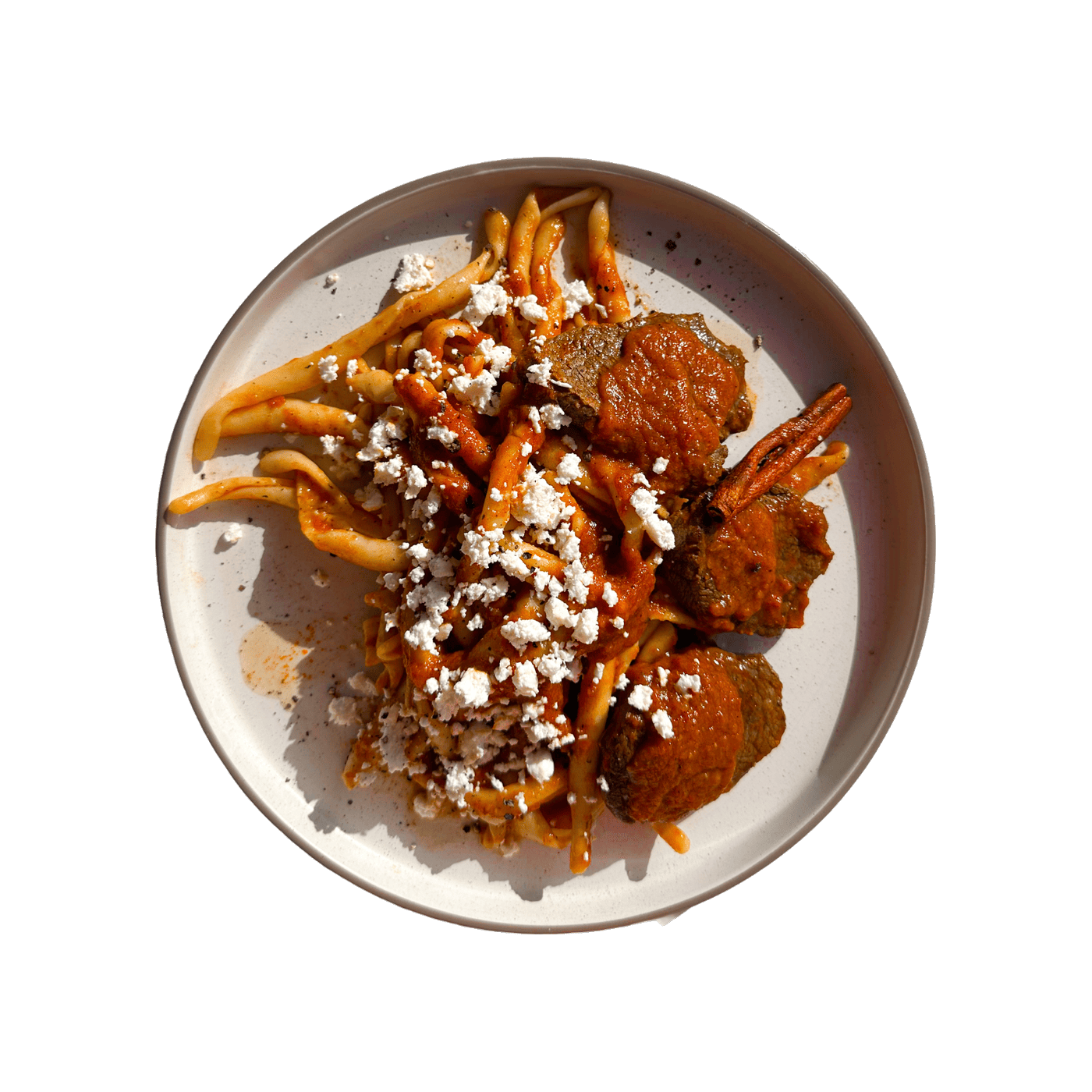 Braised veal in tomato sauce over skioufichta pasta with grated xinomyzithra