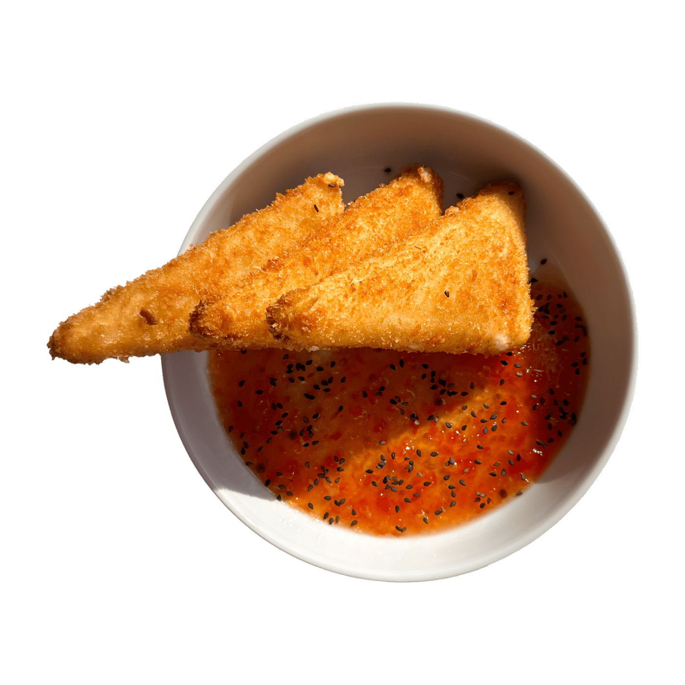 Crisp fried Sfela cheese triangles beside a bowl of tomato honey