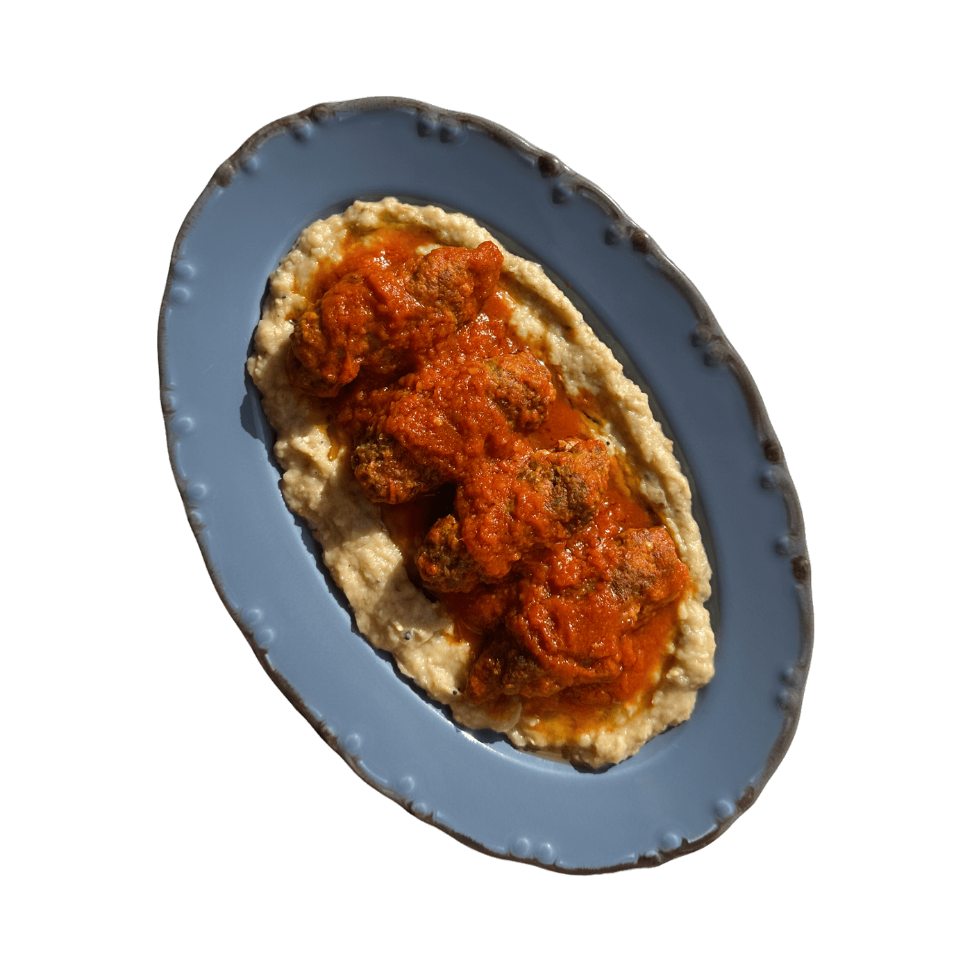 Soutzoukakia in tomato sauce on smoked aubergine puree